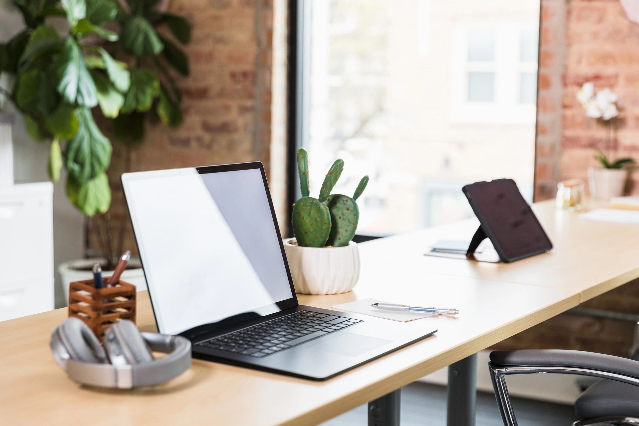 Modern workspace with laptop and notebook