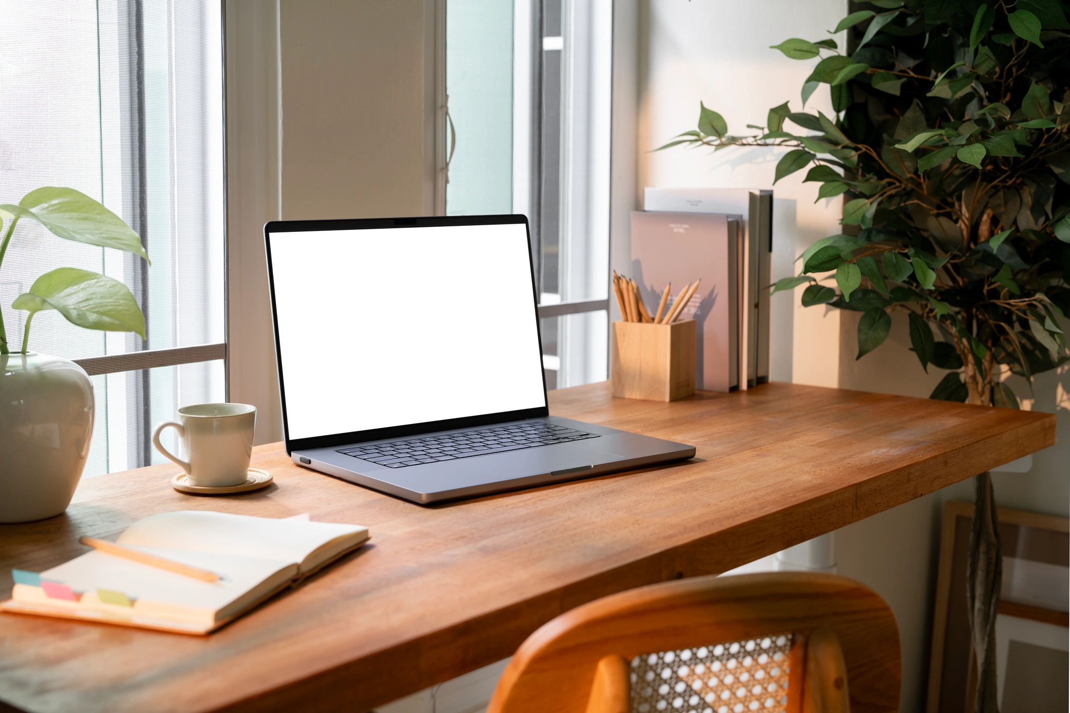 Minimal home office with laptop on a wooden desk